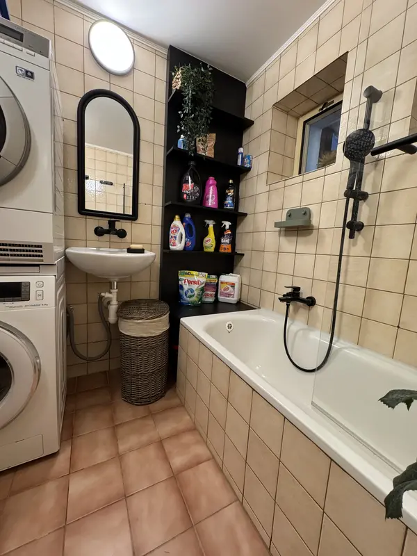 Bathroom with a washing machine and sink